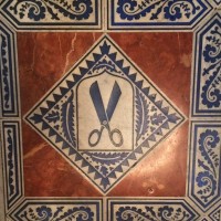 Tailor Guild sign. ceramic tiles in the floor, at the Great Hall, the Saló de Cent, 